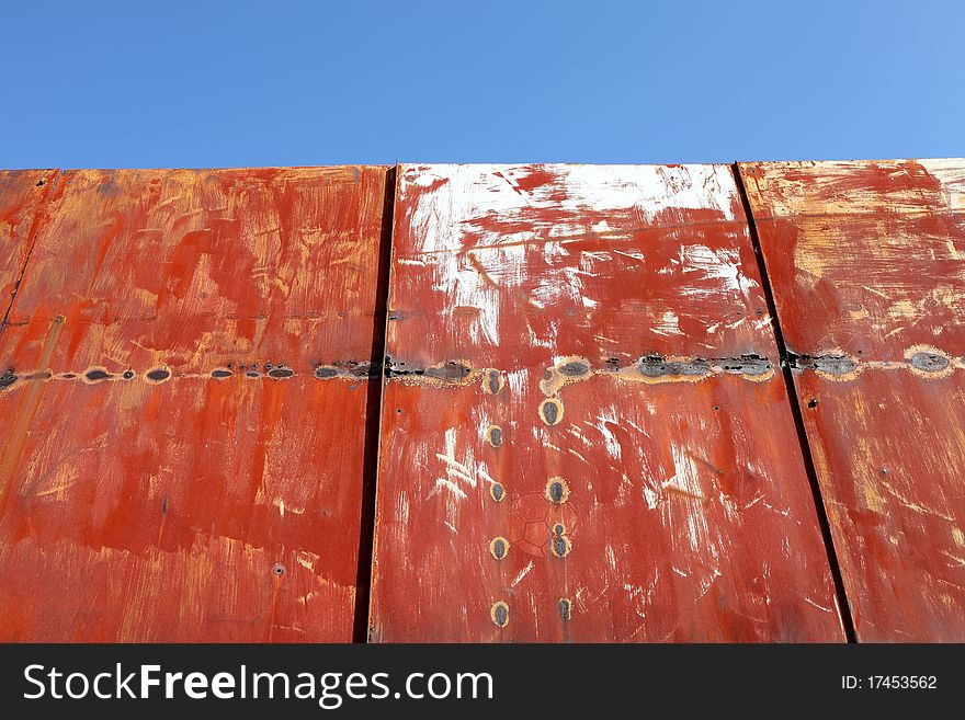 Rusted metal wall and blue sky. Rusted metal wall and blue sky