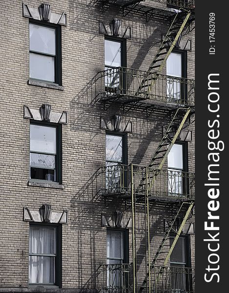 House wall with typical fire escape stairs in New York