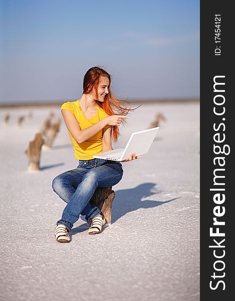 Girl with notebook on the sand