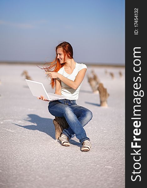 Girl with notebook on the sand