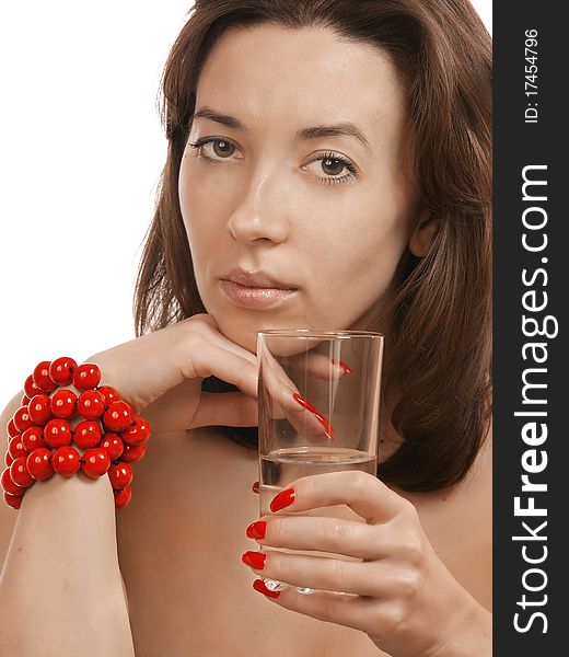 Young girl with a glass of tea and a red beads. Young girl with a glass of tea and a red beads