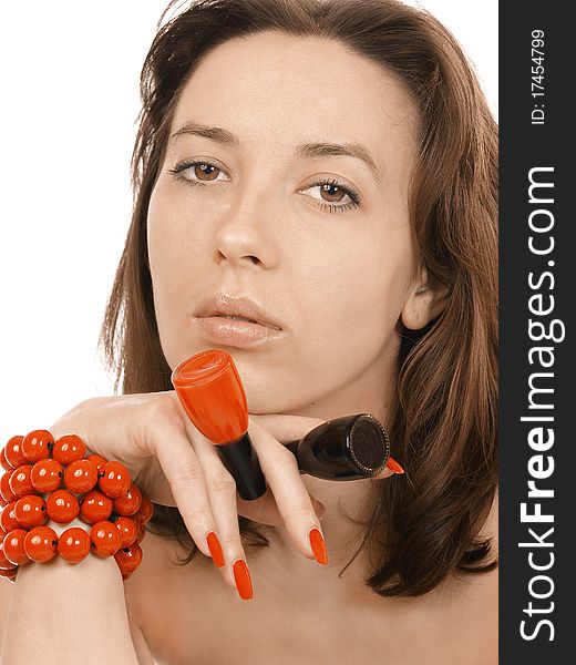 Girl in a red beads holds nail polish. Girl in a red beads holds nail polish