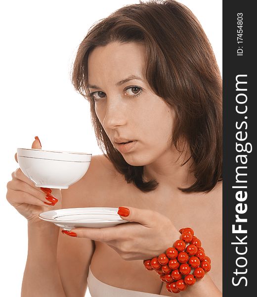 Young girl with a cup of tea and a red beads. Young girl with a cup of tea and a red beads