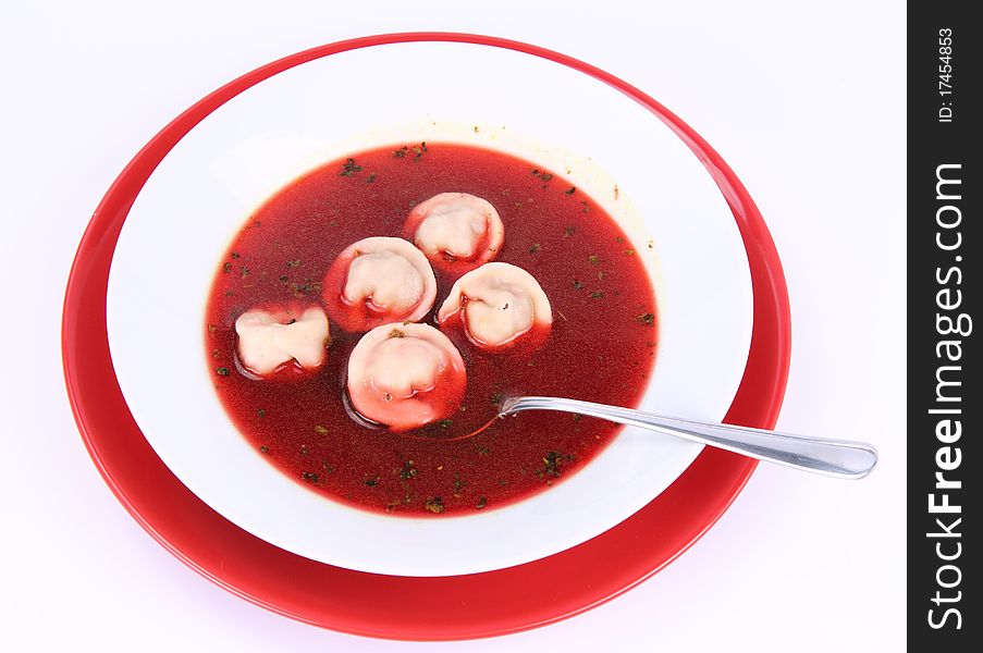 Traditional polish Christmas Eve dish: clear borscht with uszka (a mushroom filled kind of dumplings) , being eaten with a spoon. Traditional polish Christmas Eve dish: clear borscht with uszka (a mushroom filled kind of dumplings) , being eaten with a spoon