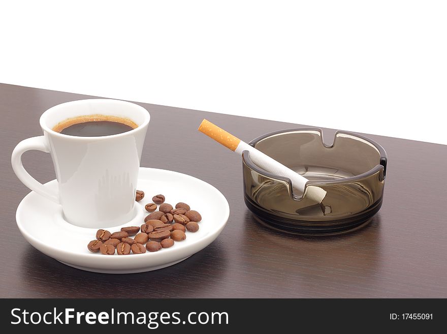 Coffee and a cigarette in an ashtray. Coffee and a cigarette in an ashtray