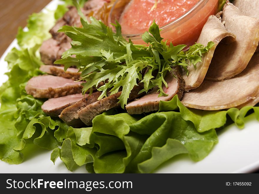 Appetizer made of  meat delicacies and salad. Appetizer made of  meat delicacies and salad