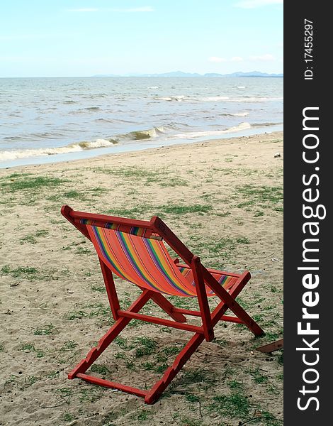 Sun beach chairs on shore near sea