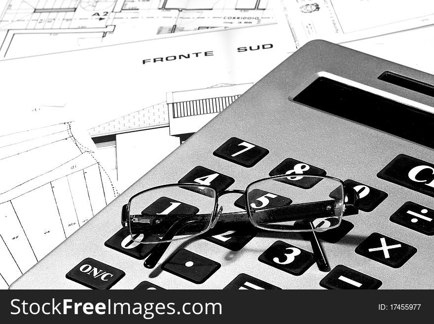 Calculator and eyeglasses with technical drawings. Calculator and eyeglasses with technical drawings