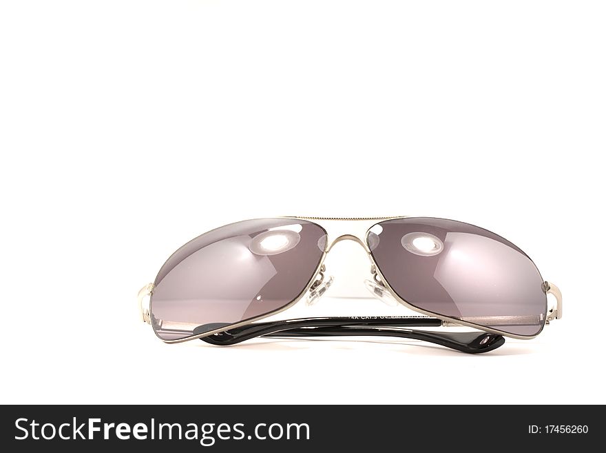 Close view detail of a pair of dark shades isolated on a white background.