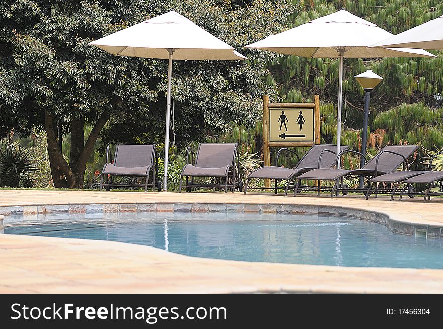 Sun chairs standing next to a swimming pool