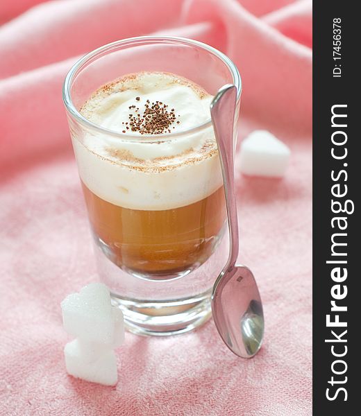 Cafe Latte in glass with spoon and sugar on plate. Cafe Latte in glass with spoon and sugar on plate