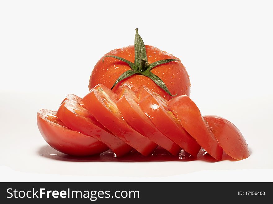 Close view detail of a bunch of red tomatoes isolated on a white background.