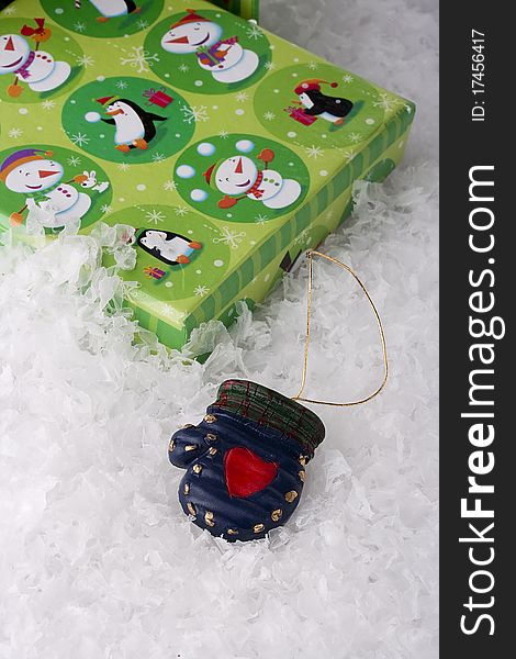 Green gift box for Christmas on a background of decorative snow.