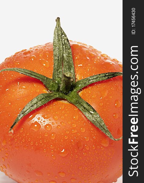 Close view detail of a red tomatoe isolated on a white background.