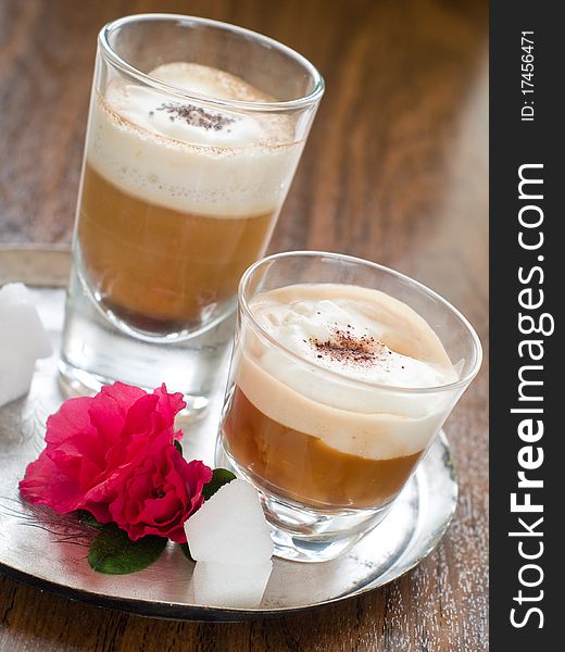 Cafe Latte in glass with spoon on plate. Cafe Latte in glass with spoon on plate