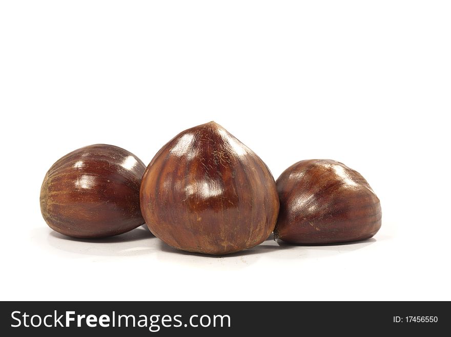 Close view detail of a bunch of chestnuts isolated on a white background. Close view detail of a bunch of chestnuts isolated on a white background.