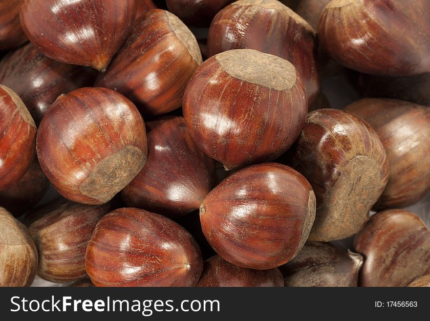 Close view of a bunch of brown chestnuts.