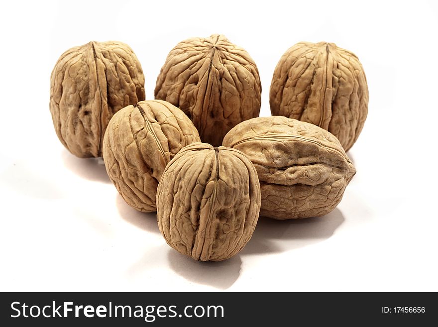 Close view detail of  some walnuts  isolated on a white background. Close view detail of  some walnuts  isolated on a white background.