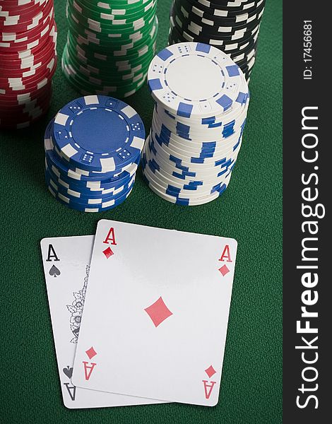 Close-up of Poker cards and gambling chips on green background