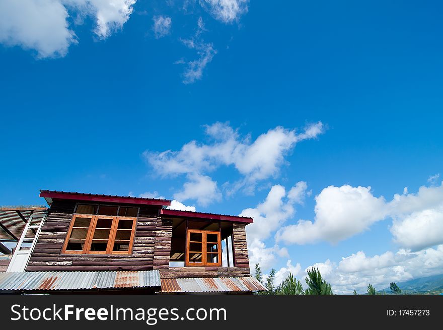 Old colorful wooden home over the blue sky