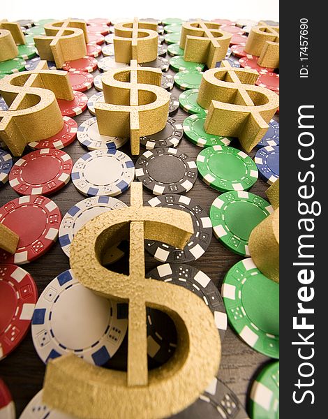 Multi - colored gambling chips and US dollar sign on a background. Multi - colored gambling chips and US dollar sign on a background