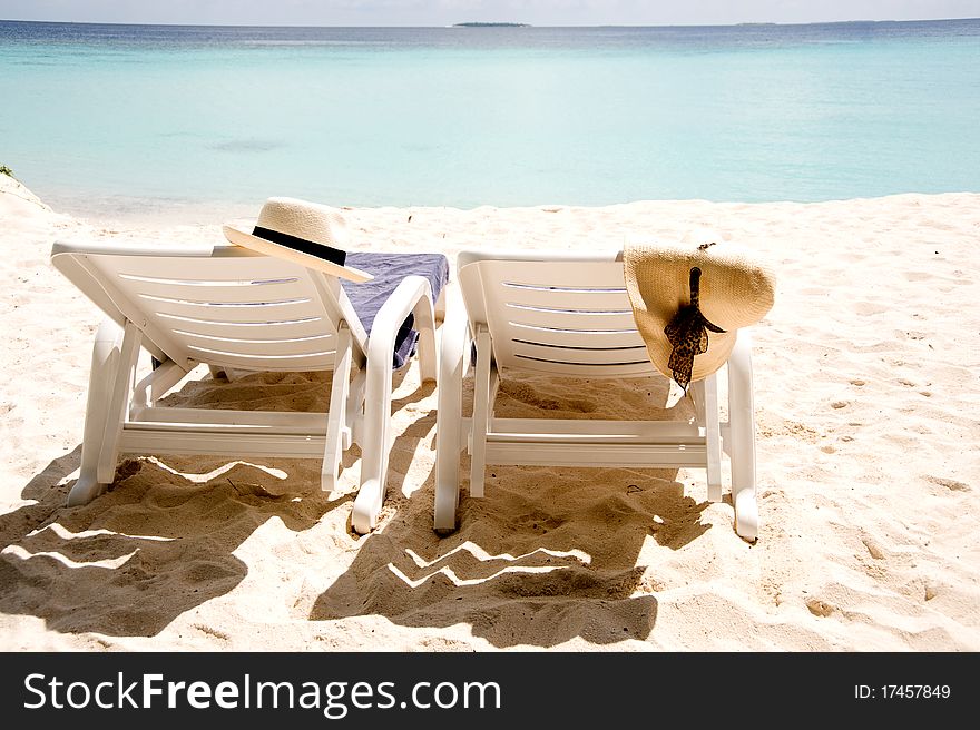 Two sun loungers on the beach in Maldives