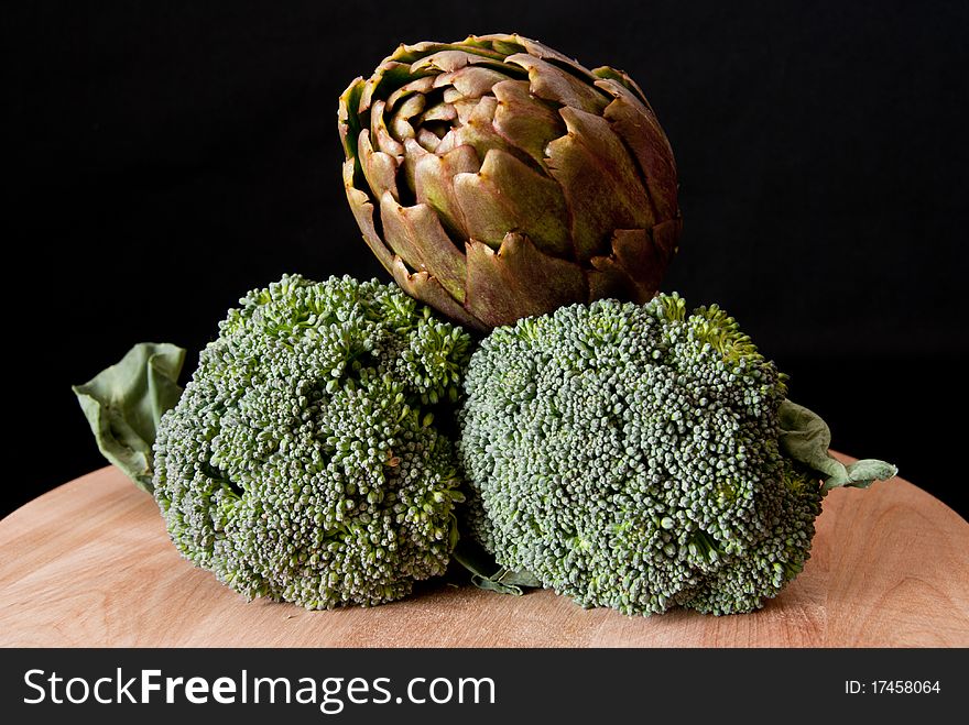 Two broccoli and one artichoke. Two broccoli and one artichoke