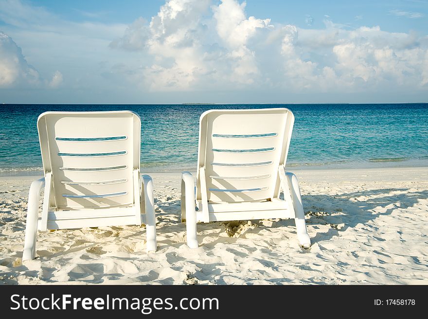 Two sun loungers on the beach in Maldives