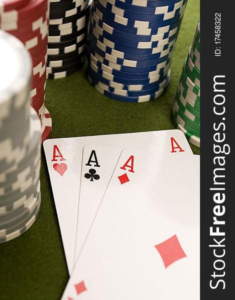 Close-up of Poker cards and gambling chips on green background
