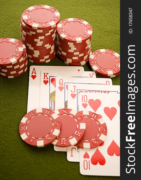 Close-up of Poker cards and gambling chips on green background