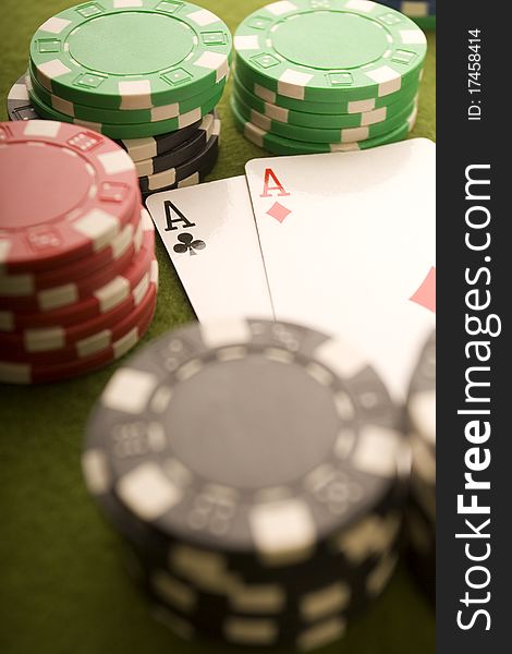 Close-up of Poker cards and gambling chips on green background. Close-up of Poker cards and gambling chips on green background