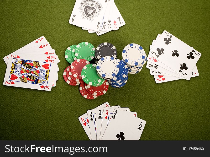 Close-up of Poker cards and gambling chips on green background. Close-up of Poker cards and gambling chips on green background