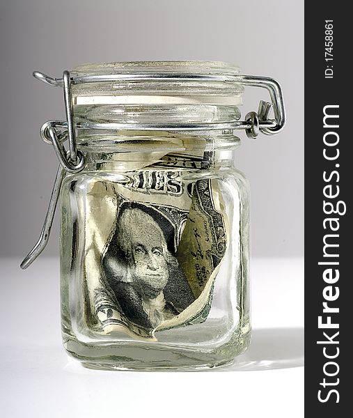 Dollar bill enclosed in a glass jar