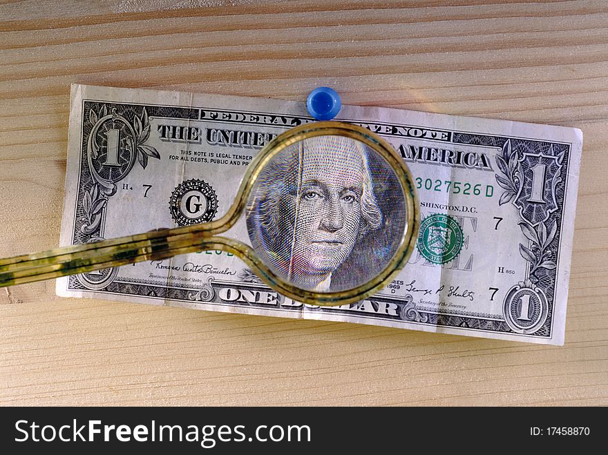 Dollar bill seen with a magnifying glass