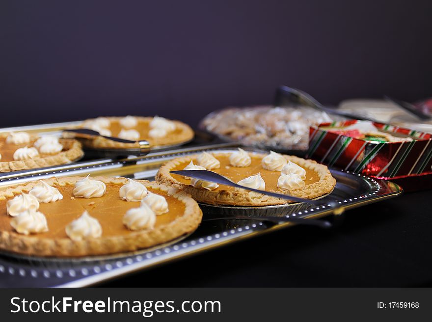 Delicious pumpkin pies and other desserts spread out on a table. Delicious pumpkin pies and other desserts spread out on a table