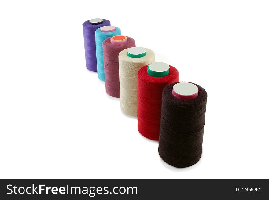 Coils of sewing threads are isolated on a white background