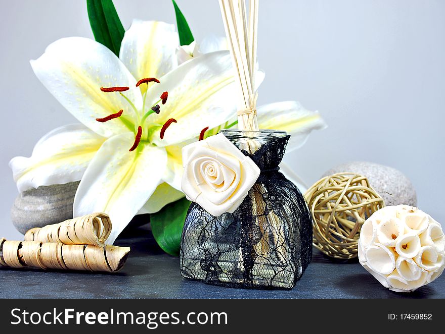 Lace covered room fragrance flacon, decorated with lilies