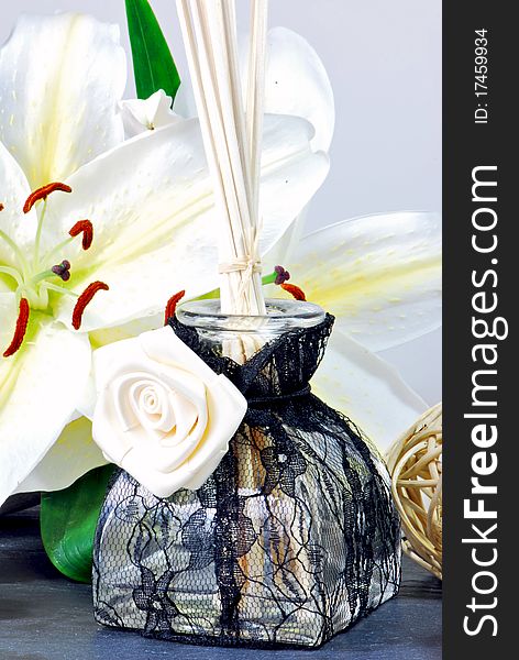 Lace covered room fragrance flacon, decorated with lilies