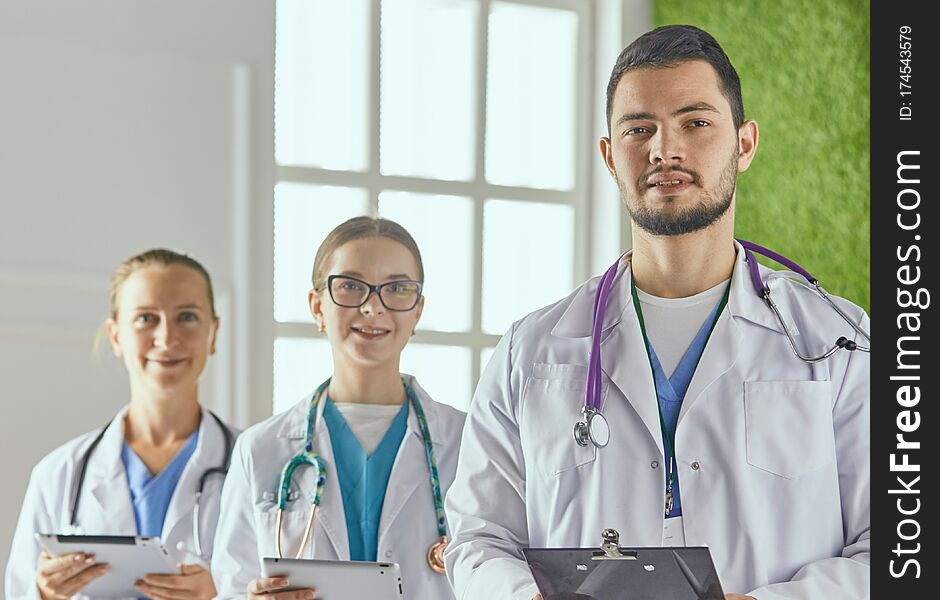 Portrait Of Group Of Smiling Hospital Colleagues Standing Together