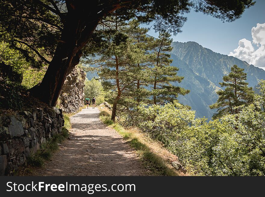 Hikers Climbing A Mountain Path In The Pyrenees