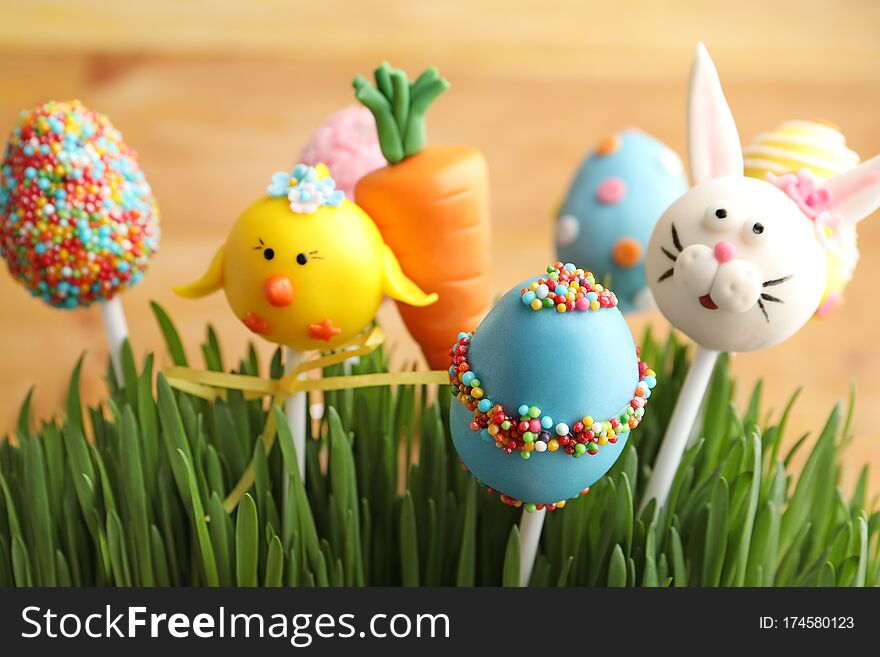 Delicious Sweet Cake Pops In Green Grass, Closeup. Easter Holiday