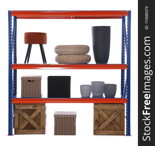 Bright metal shelving unit with wooden crates and different household stuff on white background