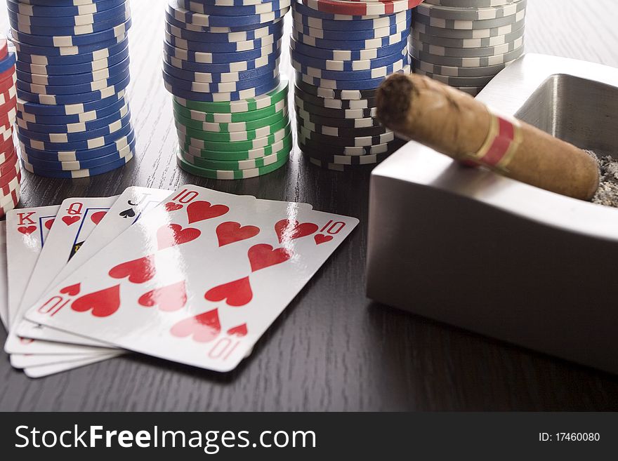 Close-up of Poker cards and gambling chips on green background. Close-up of Poker cards and gambling chips on green background