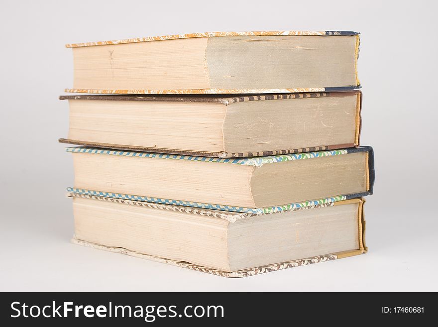 Four vintage books piled and stacked on top of each other. Four vintage books piled and stacked on top of each other