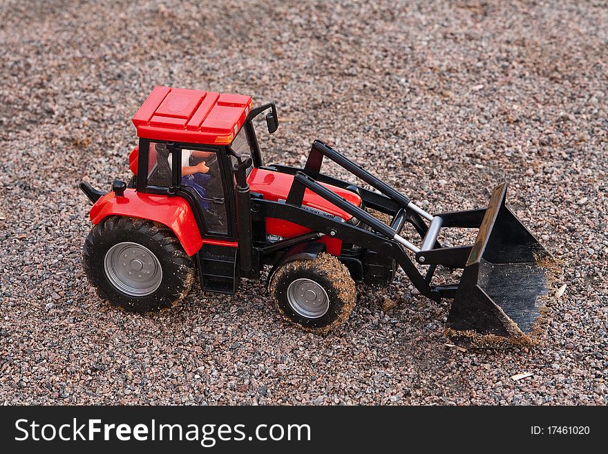 Red bulldozer on pebble sand. Red bulldozer on pebble sand