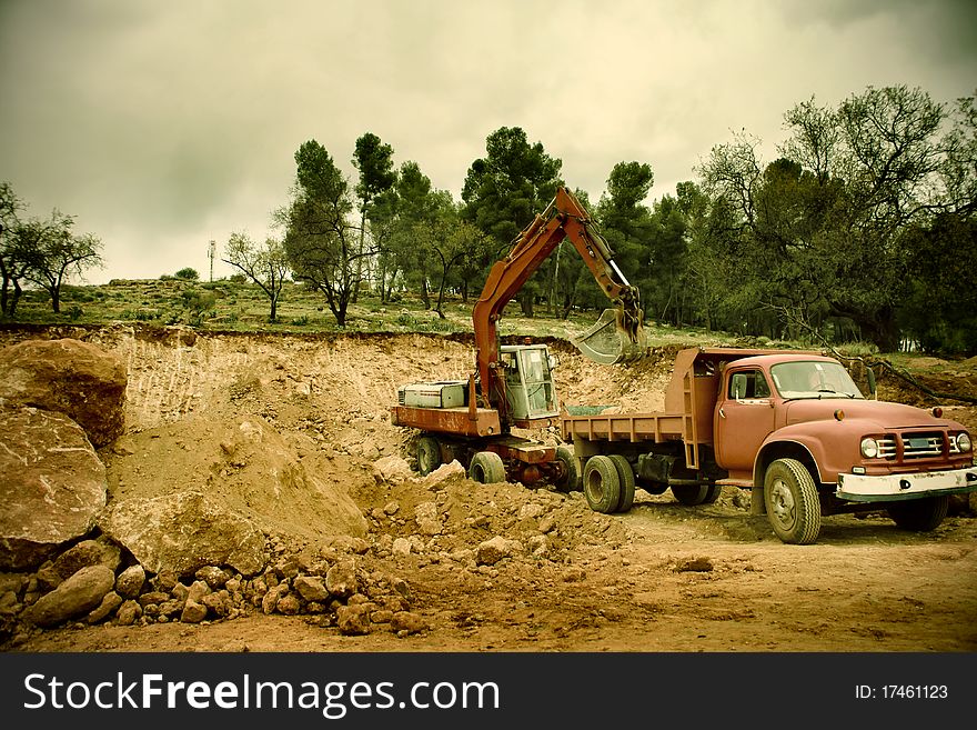 Truck and excavator in a construction site