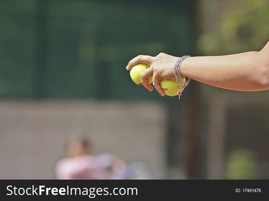 Tennis coach with two balls in left hand. Tennis coach with two balls in left hand