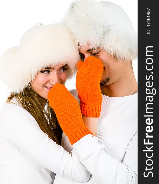 Winter happy lovers are wearing in the  fur hats and orange mittens