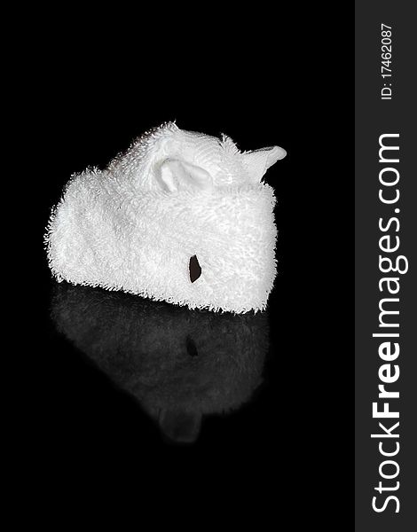White towel folded into an origami mouse isolated on a black background with a reflection. White towel folded into an origami mouse isolated on a black background with a reflection