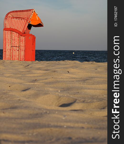 Red hooded beach chair and sea